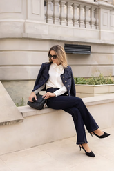a lady in a white shirt, a sequin tweed jacket and a pair of jeans